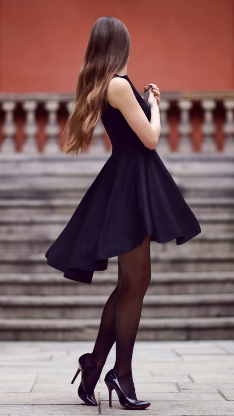 Black dress with long back, black stockings and patent leather